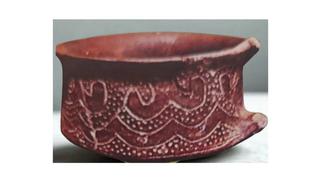 vaso di argilla con intarsi simili a una bordura da ricamo
